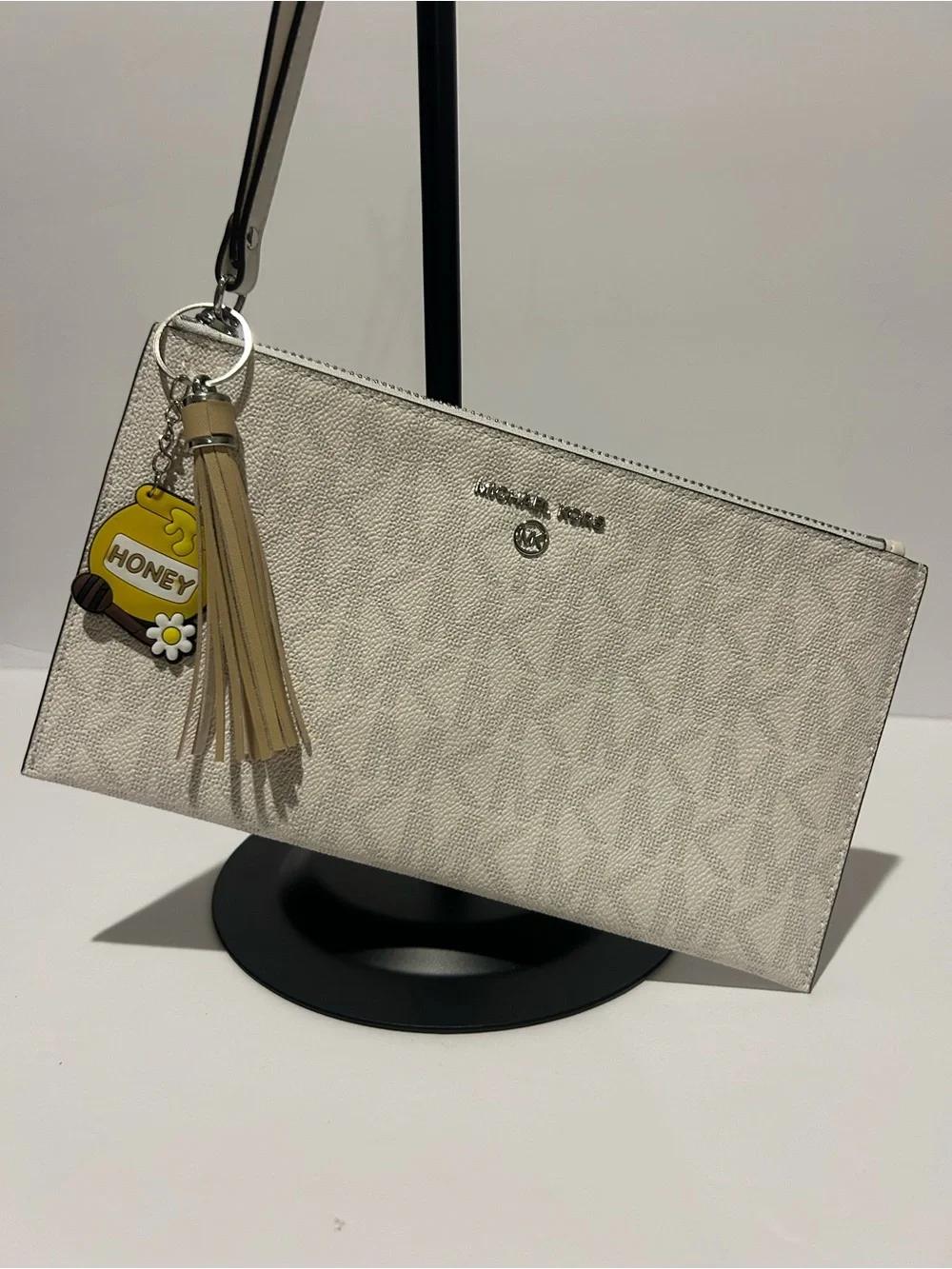 Michael Kors Cream Signature Wristlet with Tassel Charm